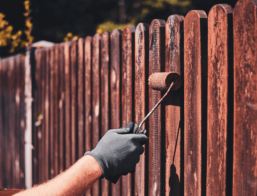 painting a wooden fence
