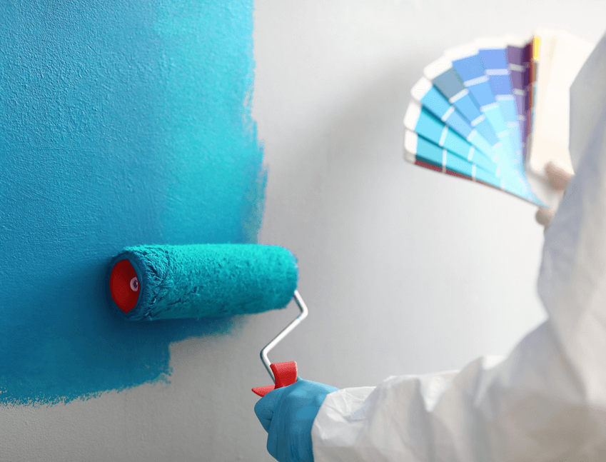 men paiting a wall with roller paint