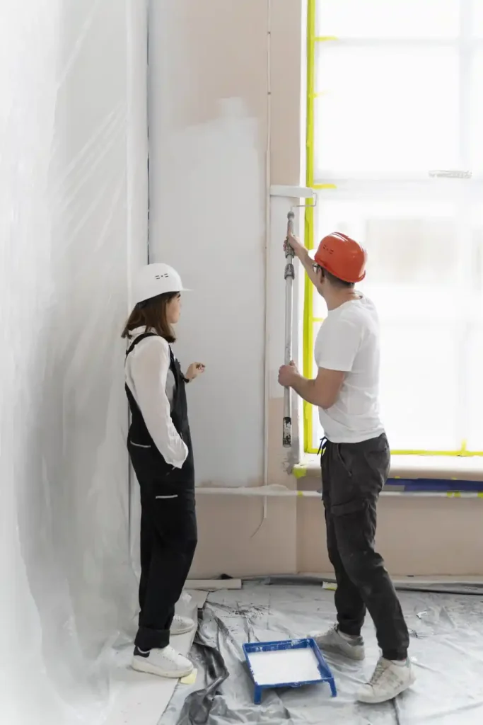 couple painting a wall with roller